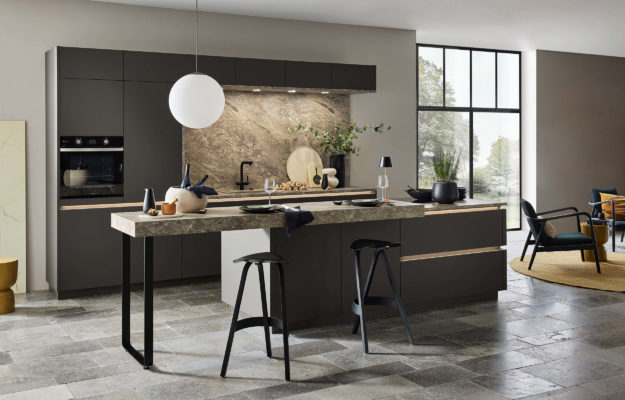 Moderne, schwarze Küche mit Granitarbeitsplatte und breiter Kochinsel mit Tresen.